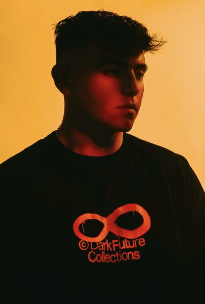 Modeā in profile against a warm orange backdrop